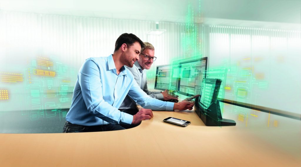 two men looking at computer screens